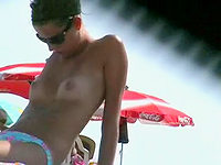 Mini bikini panty hardly covering the great treasures of this sun tanning cutie.