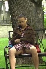 Oksana without panties sitting in a park