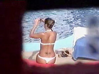 Our hunter with real pleasure voyeured the luxurious body of the girl in white bikini enjoying her rest on the beach.